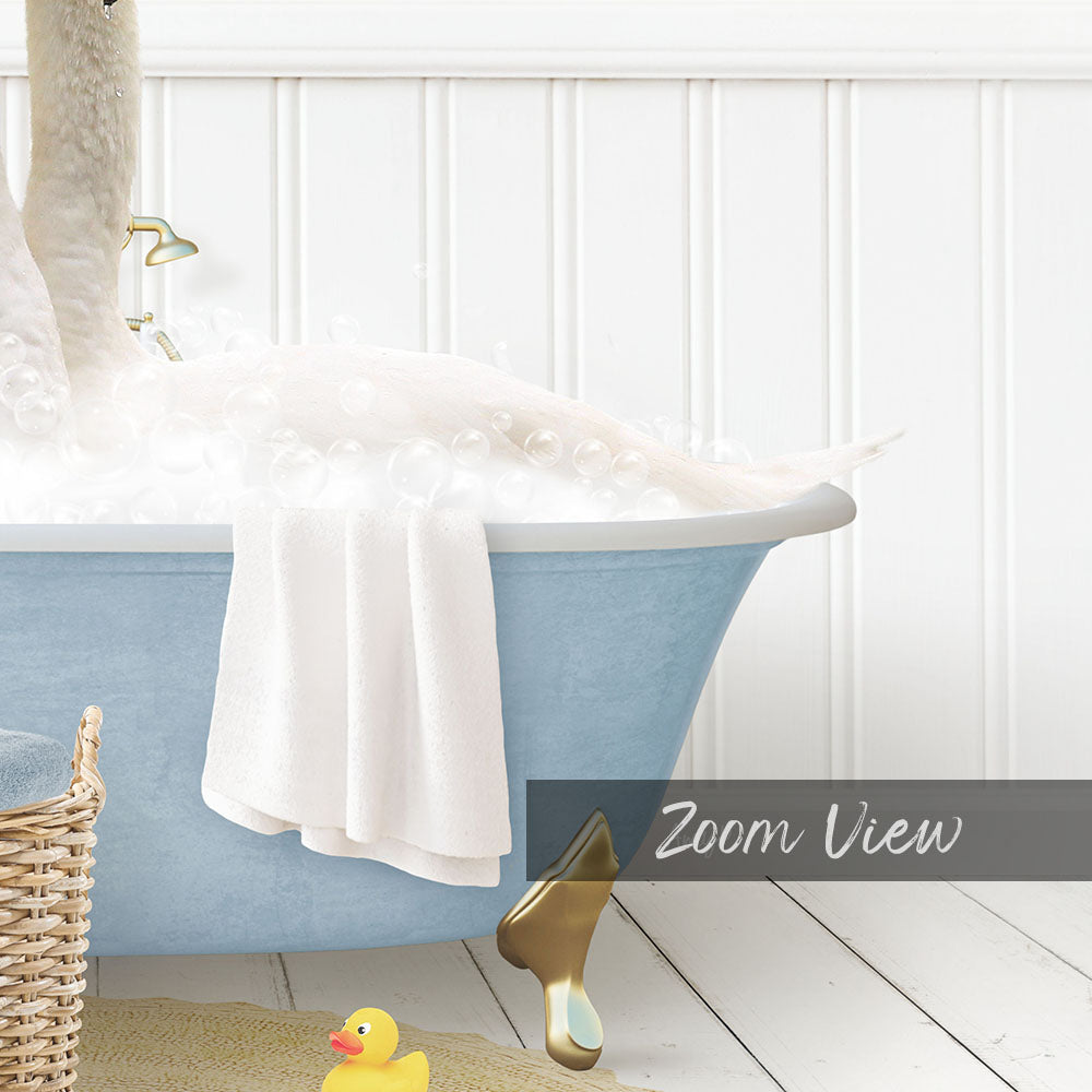 A blue claw-foot bathtub filled with bubbles, with a yellow rubber duck sitting on the edge.