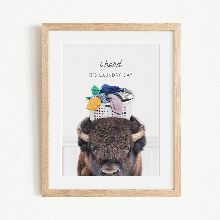 A buffalo with a basket of laundry on its head, accompanied by the text "It's laundry day"