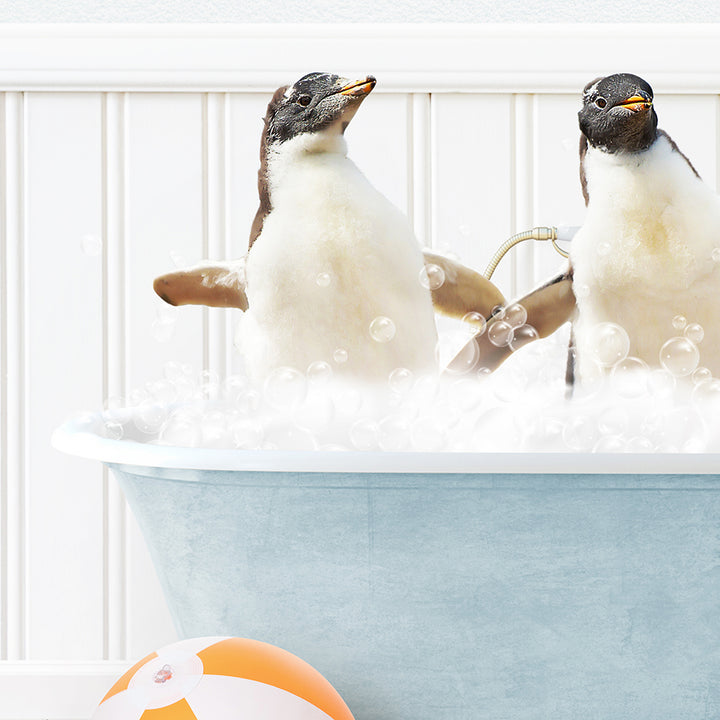 two penguins sitting in a bathtub full of bubbles