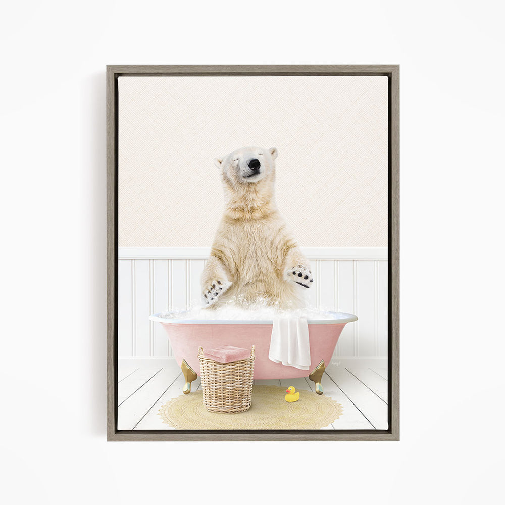 A polar bear sitting in a pink bathtub filled with bubbles, surrounded by a basket of toys and a yellow rubber duck.