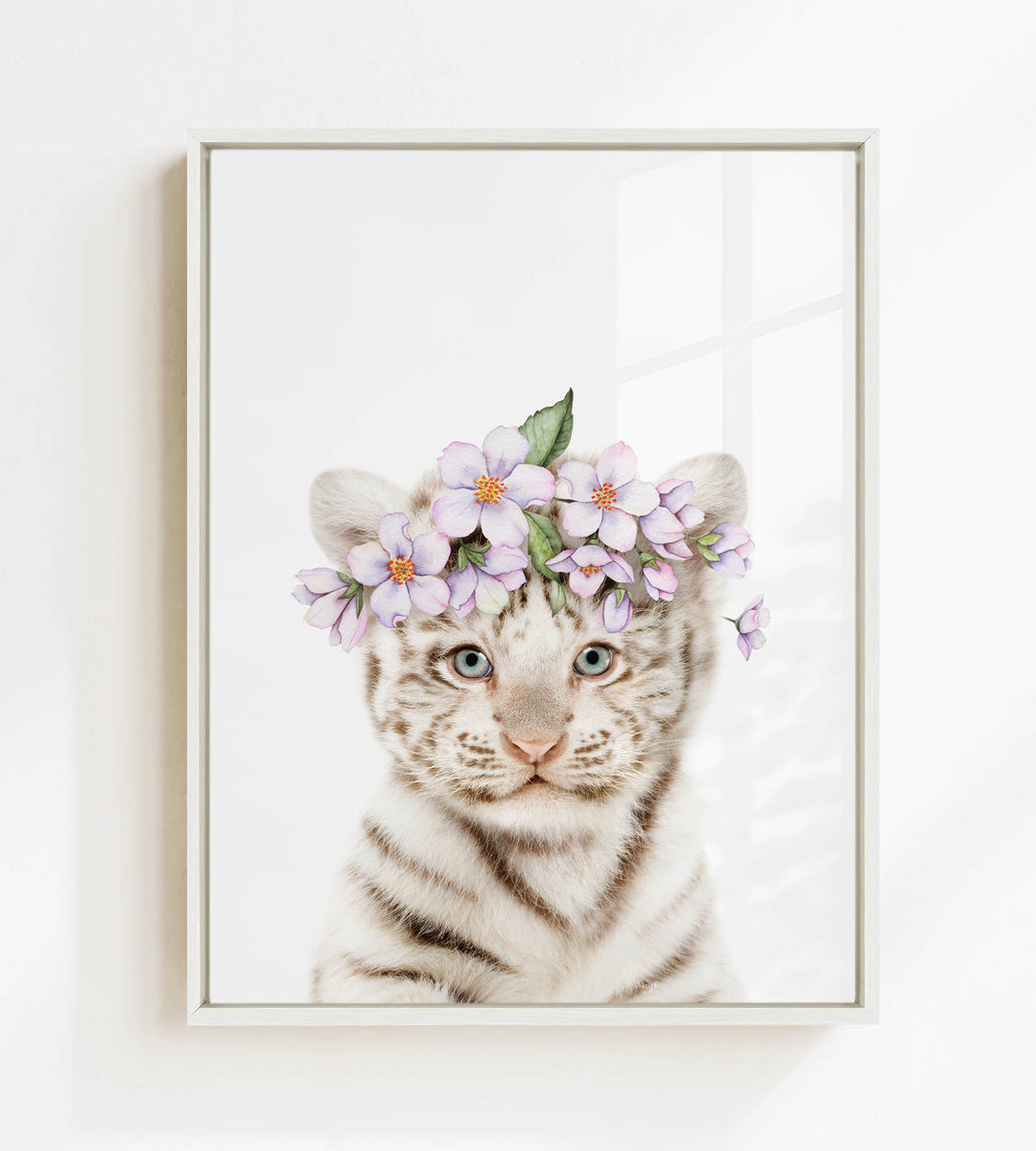 A young tiger cub wearing a floral headpiece with purple flowers.
