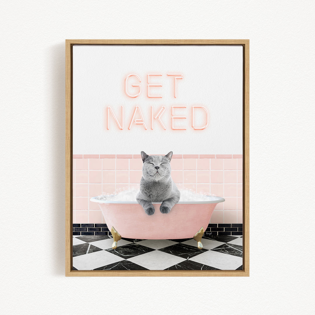 A framed image depicting a gray cat sitting in a pink bathtub filled with bubbles, with the text "GET NAKED" displayed above the cat.