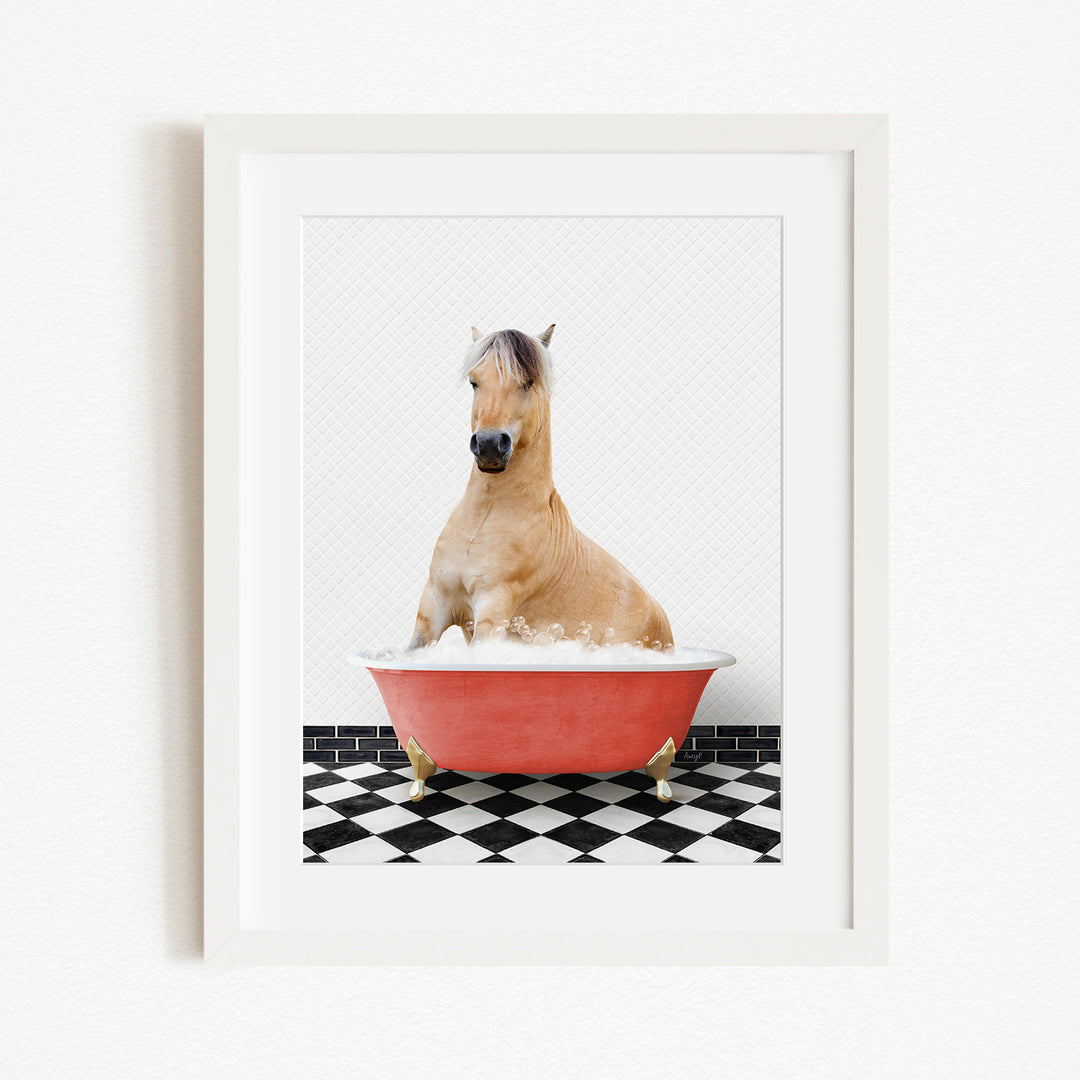 A light brown horse is sitting in a red bathtub filled with water, surrounded by a black and white checkered floor.