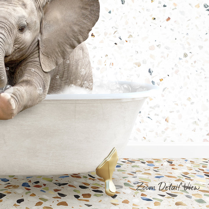 A baby elephant sitting in a bathtub filled with water, surrounded by a colorful mosaic floor.