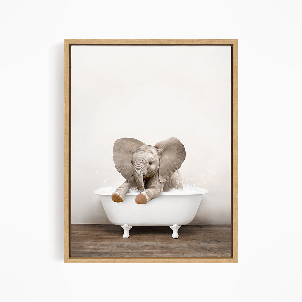 A baby elephant sitting in a white bathtub, with its trunk in the water.