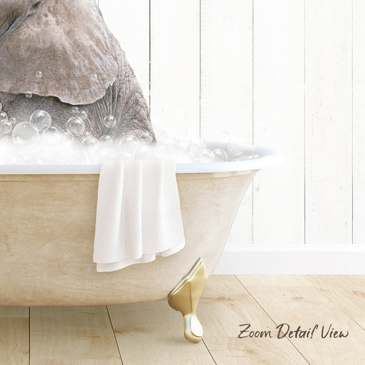 A bathtub filled with bubbles, with a towel draped over the side and a gold faucet.