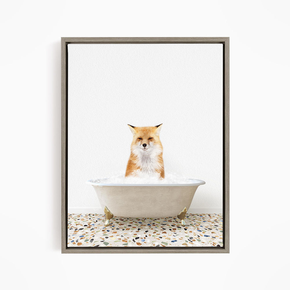 A red fox sitting in a white bathtub filled with water, looking directly at the camera.