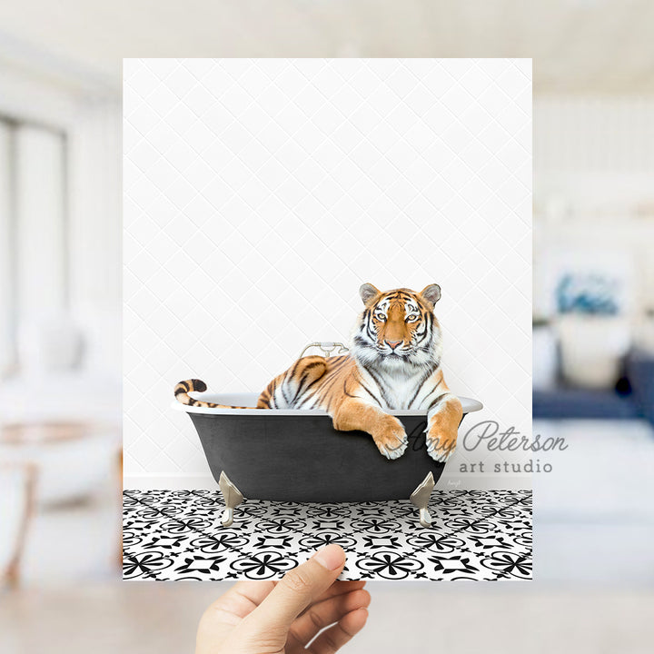 a hand holding a card with a picture of a tiger in a bathtub