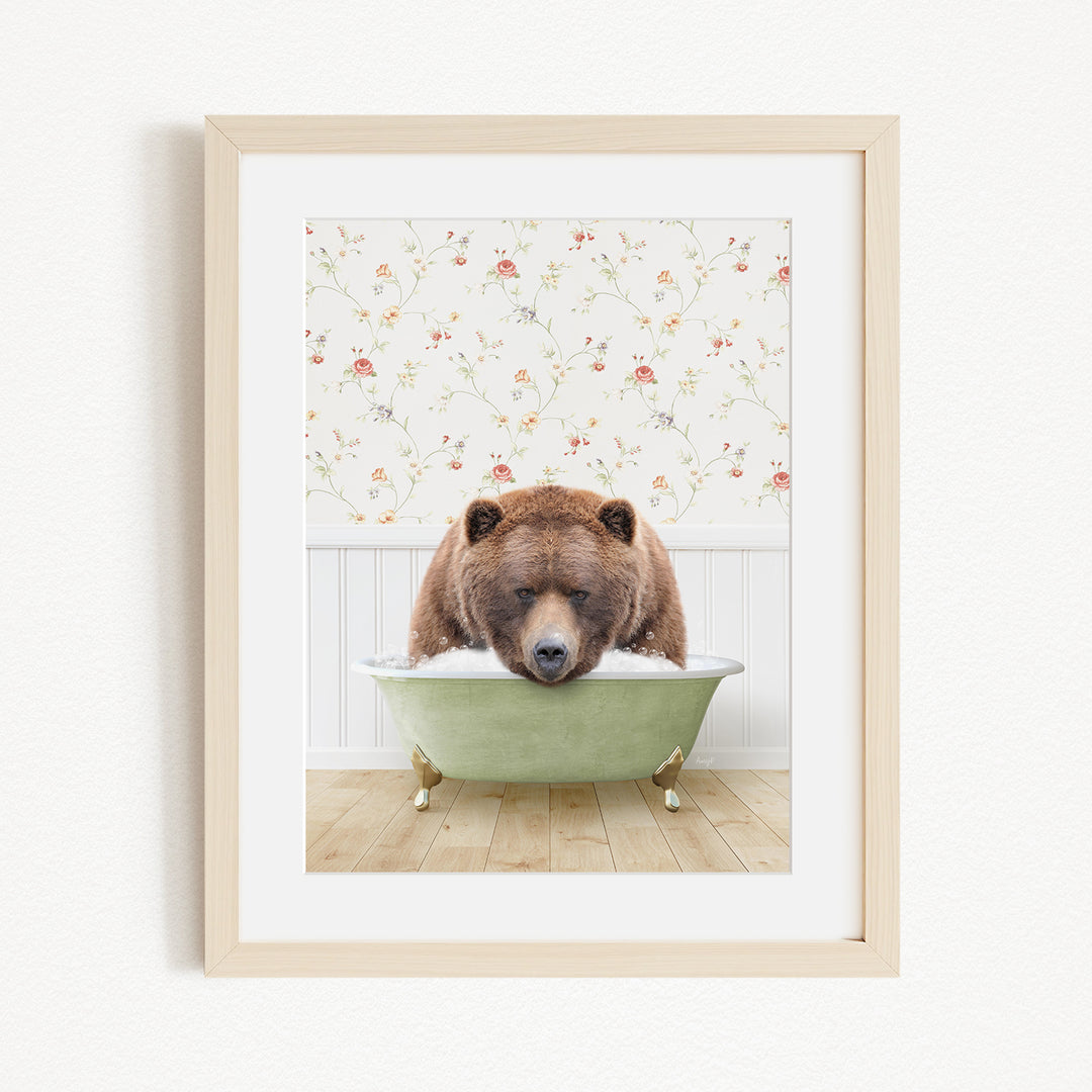 A brown bear is sitting in a green bathtub, with a floral patterned wall behind it.