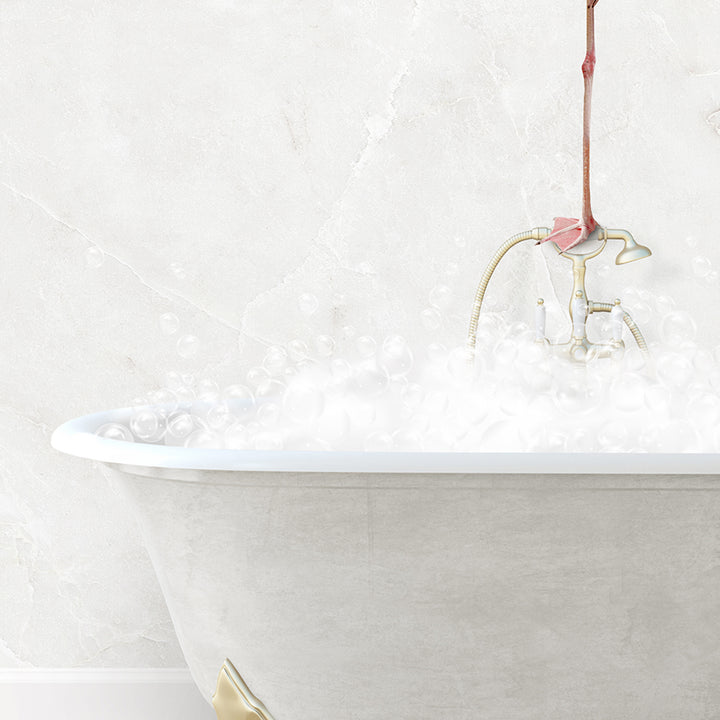 a bathtub filled with white foam and a pink flower