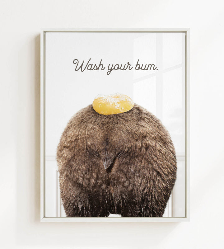 a close-up of a furry brown animal, possibly a bear, with a yellow object on its head. The text "Wash your butt" is written above the animal.