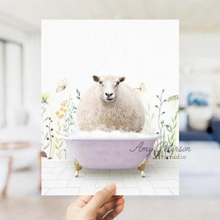 a hand holding a card with a sheep in a bathtub