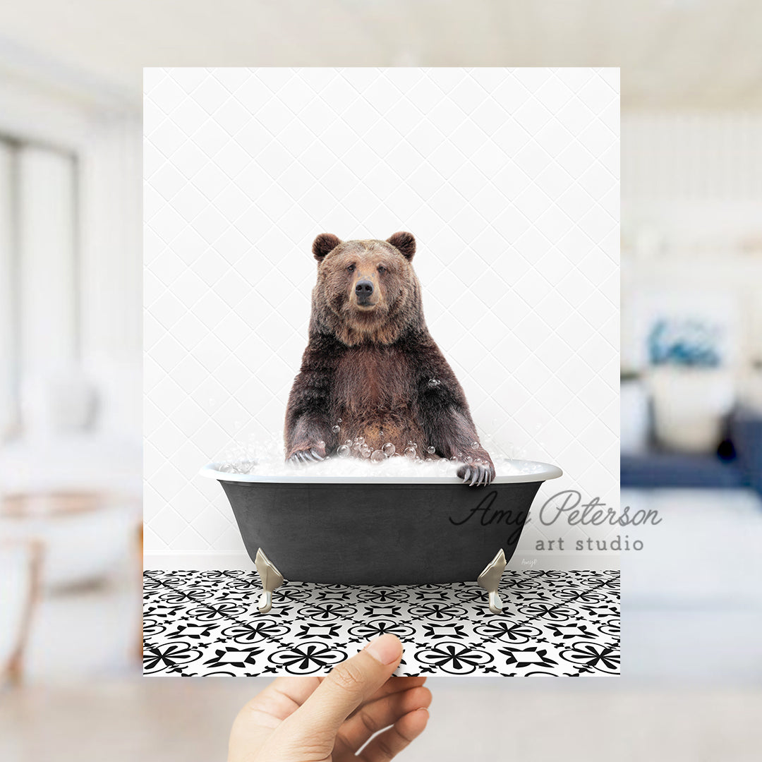 a person holding up a card with a bear in a bathtub