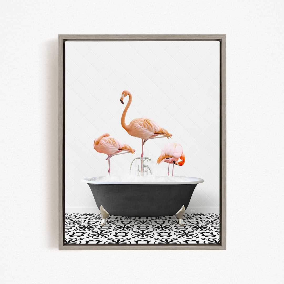 A framed image depicting three pink flamingos standing in a bathtub filled with water.