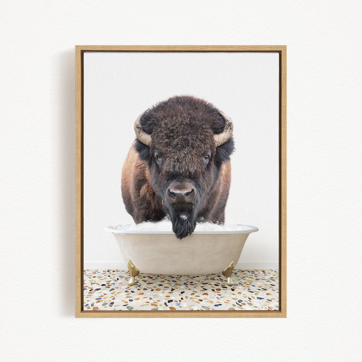 A bison with a long beard is standing in a white bathtub, with a speckled floor in the background.