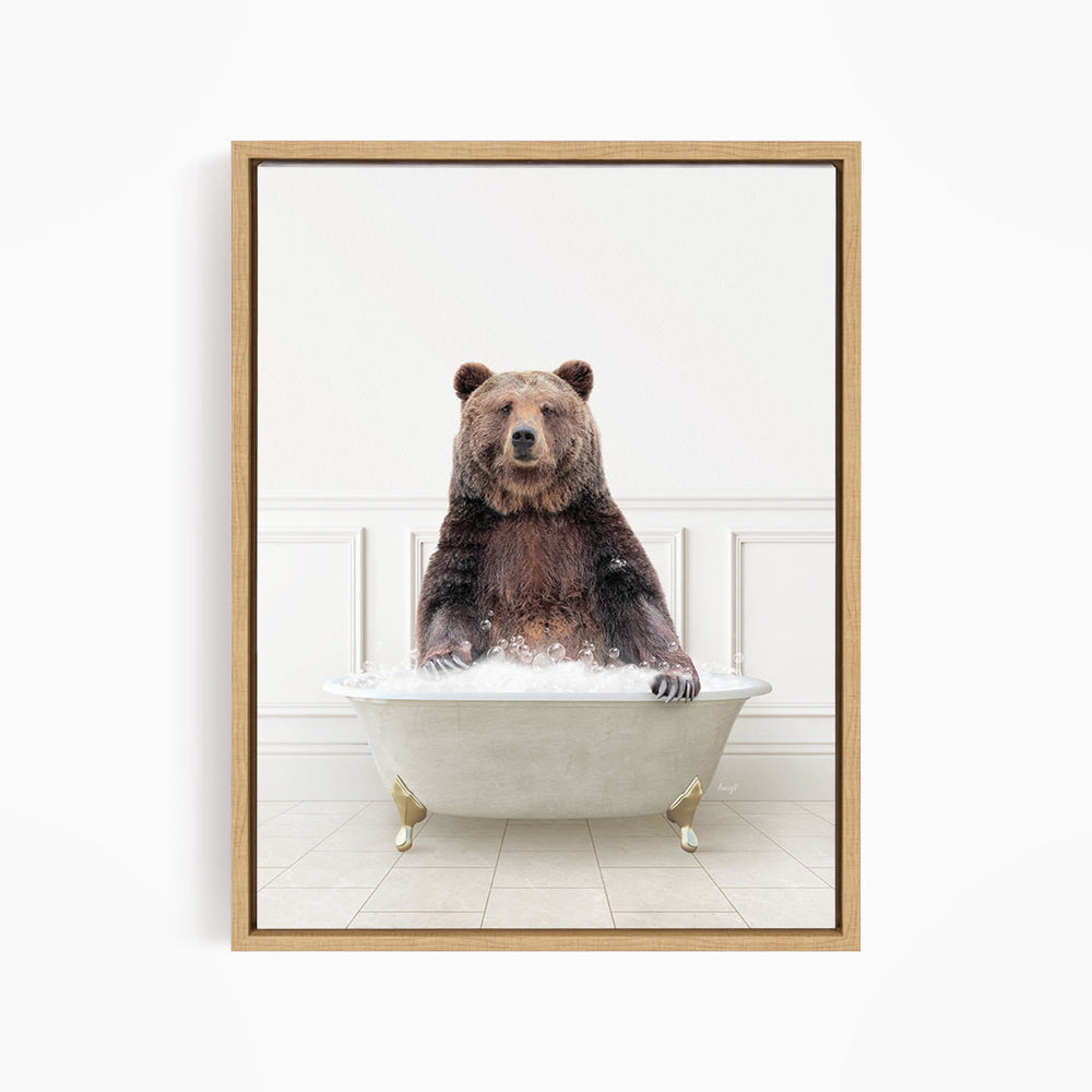 A brown bear sitting in a white bathtub filled with water, appearing to enjoy the bath.