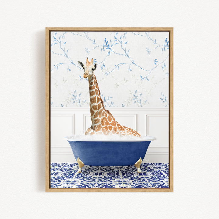 A giraffe sitting in a blue bathtub, surrounded by a blue and white patterned rug and a floral wallpaper background.