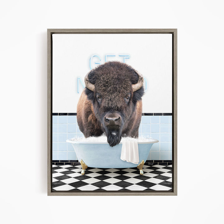 A buffalo standing in a bathtub filled with bubbles, with a sign that says "GET IN THE WASH".