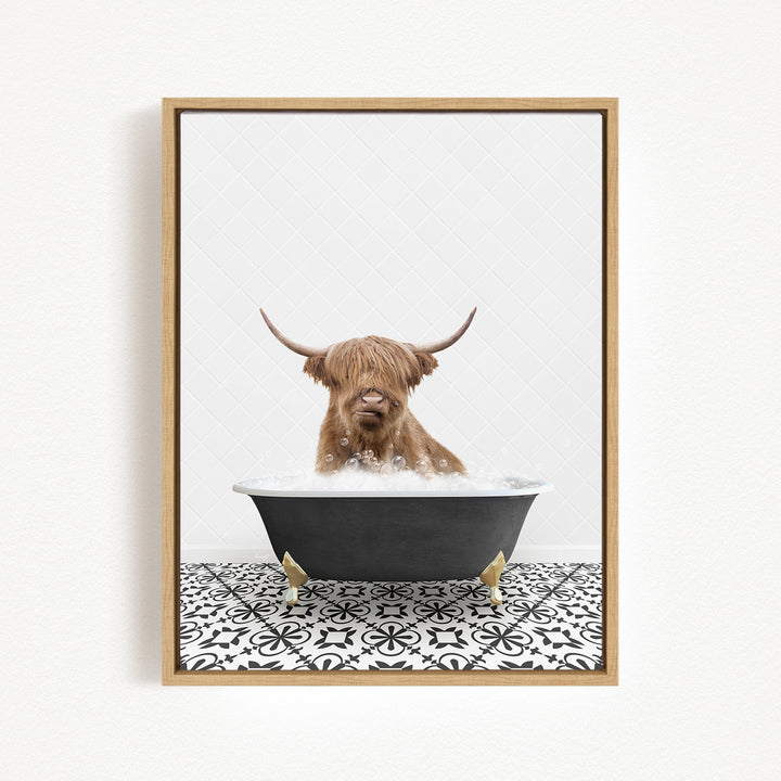 A brown cow with long horns is sitting in a black bathtub filled with water, creating a whimsical and playful scene.