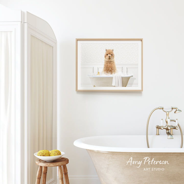 A framed image of a dog sitting in a bathtub is hanging on a white wall above a freestanding bathtub in a bathroom.