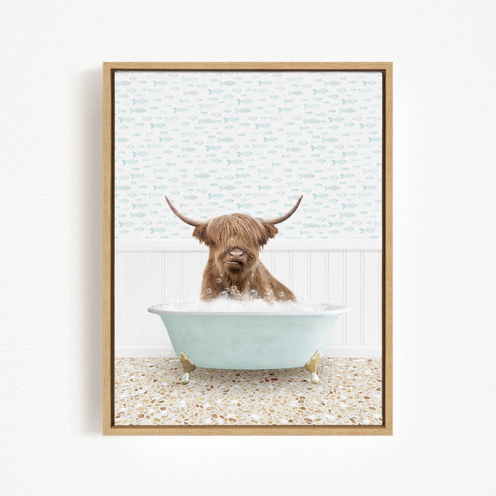 A brown cow with long horns is sitting in a light blue bathtub filled with bubbles, creating a whimsical and playful scene.