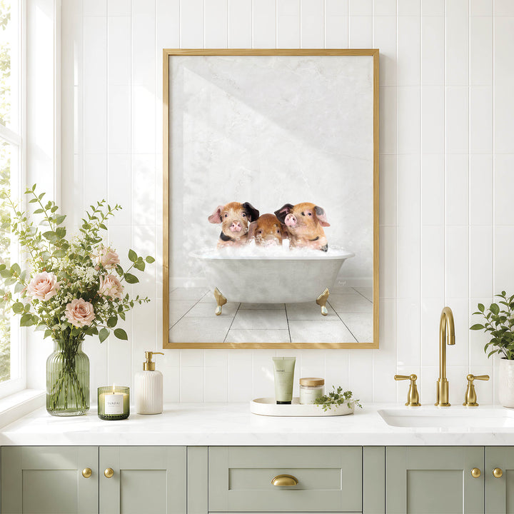 A framed image of three adorable pigs sitting in a bathtub, surrounded by flowers, is displayed on the wall above a bathroom sink.