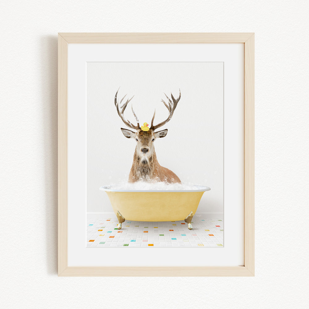 A deer with antlers is sitting in a yellow bathtub filled with water, with a yellow rubber duck perched on its head.