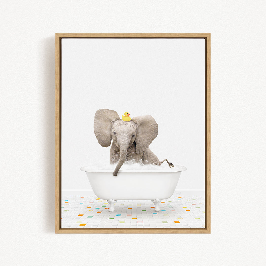 A gray elephant is sitting in a white bathtub filled with water, with a yellow rubber duck floating on its head.