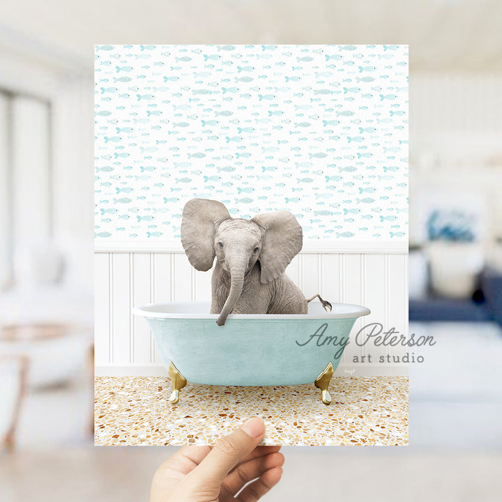 a hand holding up a card with an elephant in a bathtub