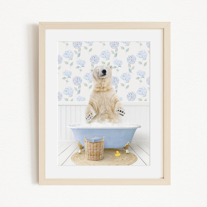 A polar bear standing in a blue bathtub filled with water, surrounded by a floral patterned wall and a basket of rubber ducks.