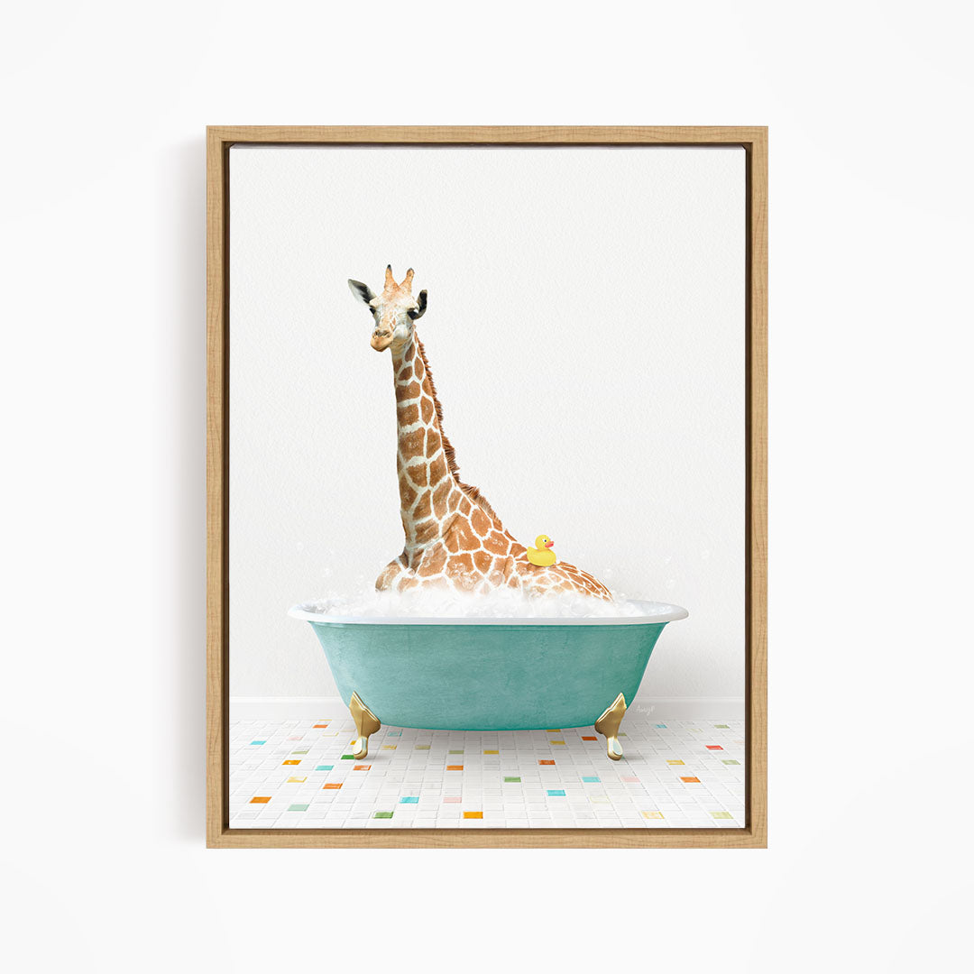 A giraffe is sitting in a blue bathtub filled with bubbles, with a yellow rubber duck floating on the water.