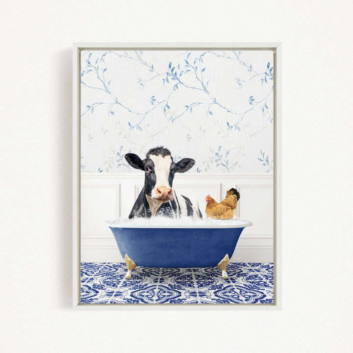 A black and white cow is sitting in a blue bathtub, with a chicken standing nearby, in a room with a blue and white floral patterned wall.