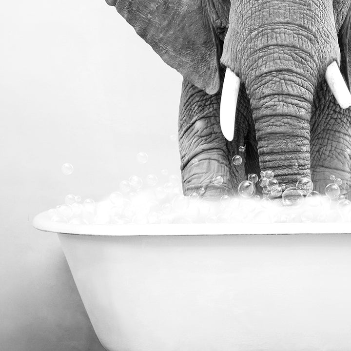 an elephant standing in a bathtub full of bubbles