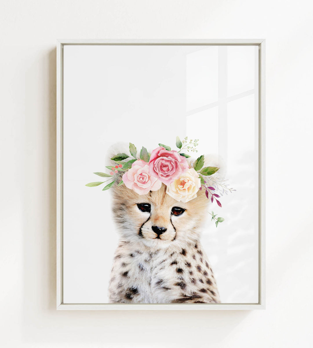A cheetah wearing a floral crown of pink and white roses and greenery.