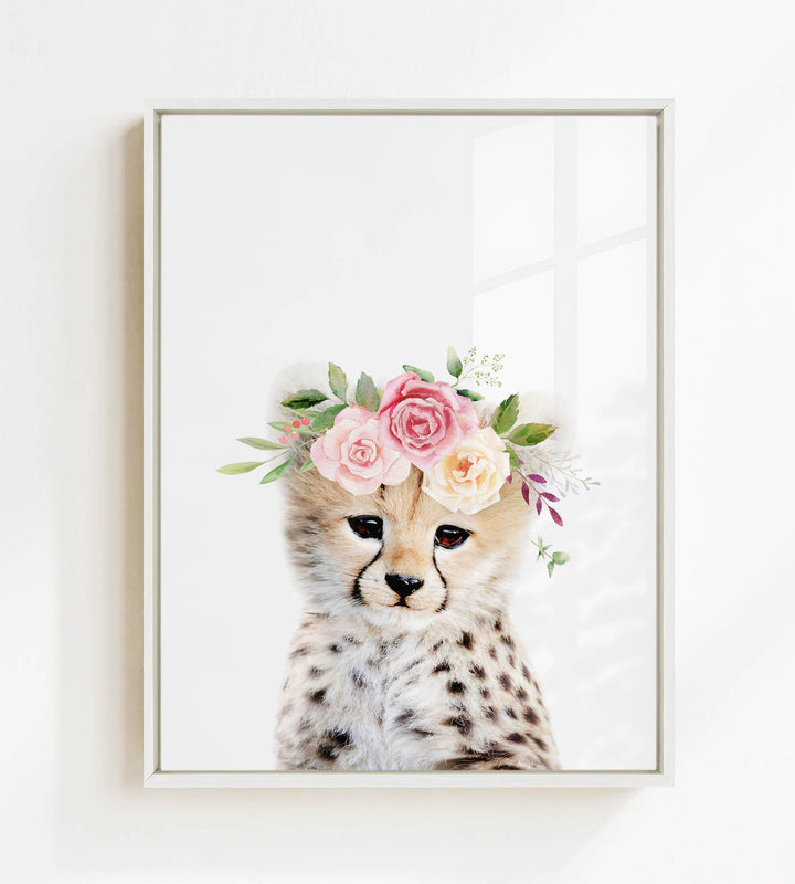 A cheetah wearing a floral crown of pink and white roses and greenery.