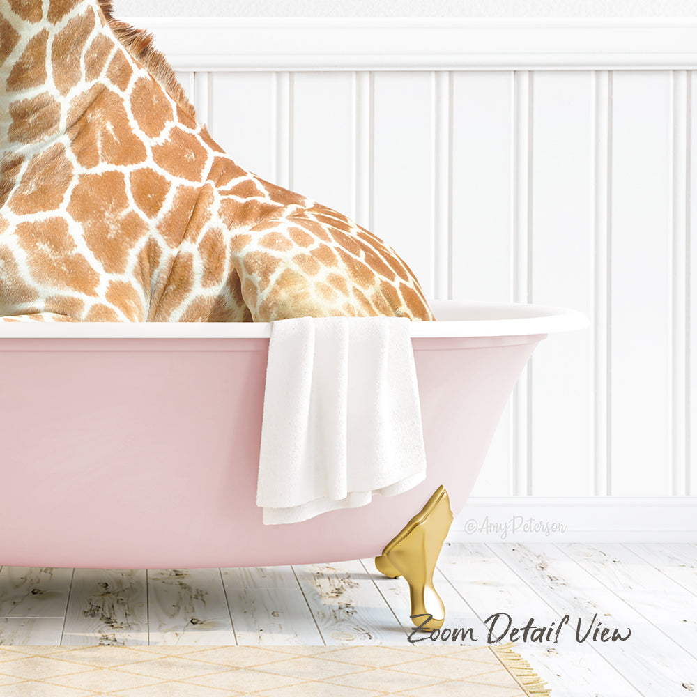 A giraffe is sitting in a pink bathtub, with a white towel and gold shoe placed on the side of the tub.