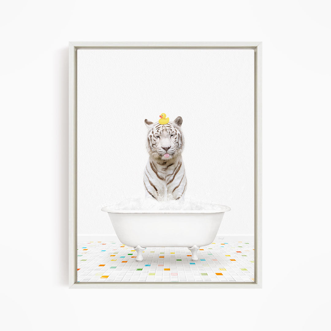 A white tiger is sitting in a white bathtub, with a yellow rubber duck perched on its head.