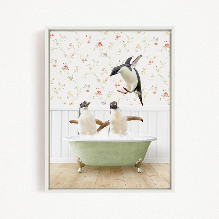A framed image depicting two penguins sitting in a green bathtub, with one penguin flying towards the other in mid-air.