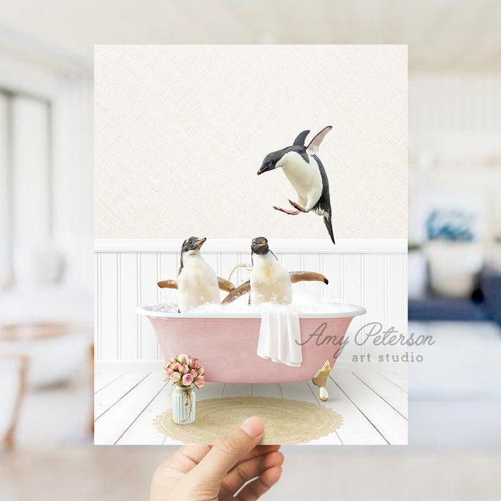 a hand holding a card with penguins in a bathtub