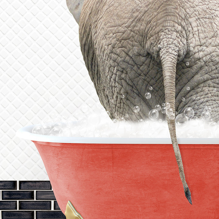 an elephant taking a bath in a red bathtub