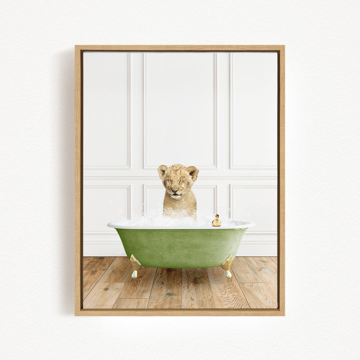 A young lion cub sitting in a green bathtub filled with water, with a rubber duck floating nearby.