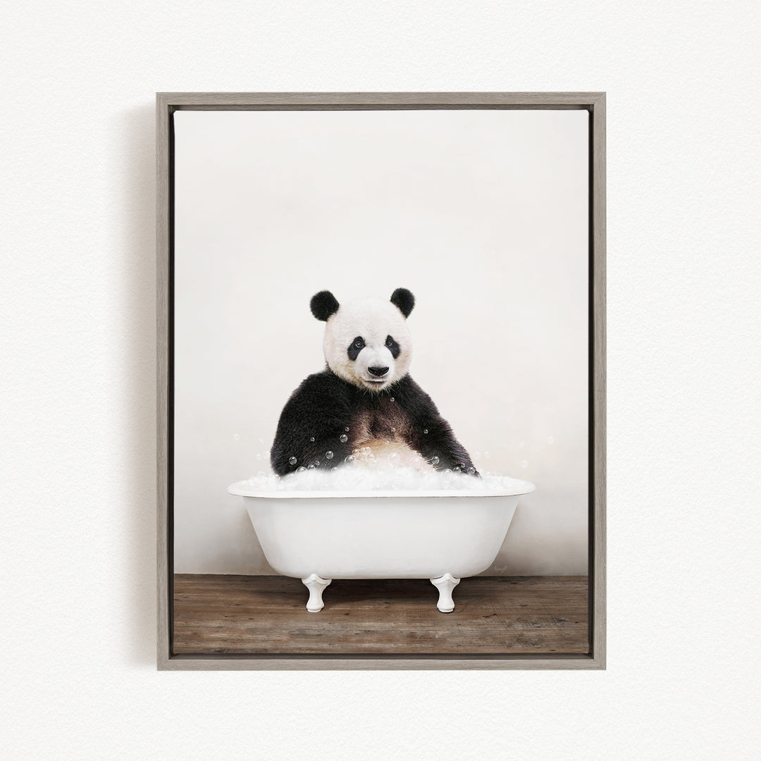 A panda bear sitting in a white bathtub filled with bubbles, looking directly at the camera.