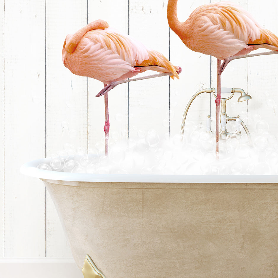 two pink flamingos standing in a bathtub filled with foam