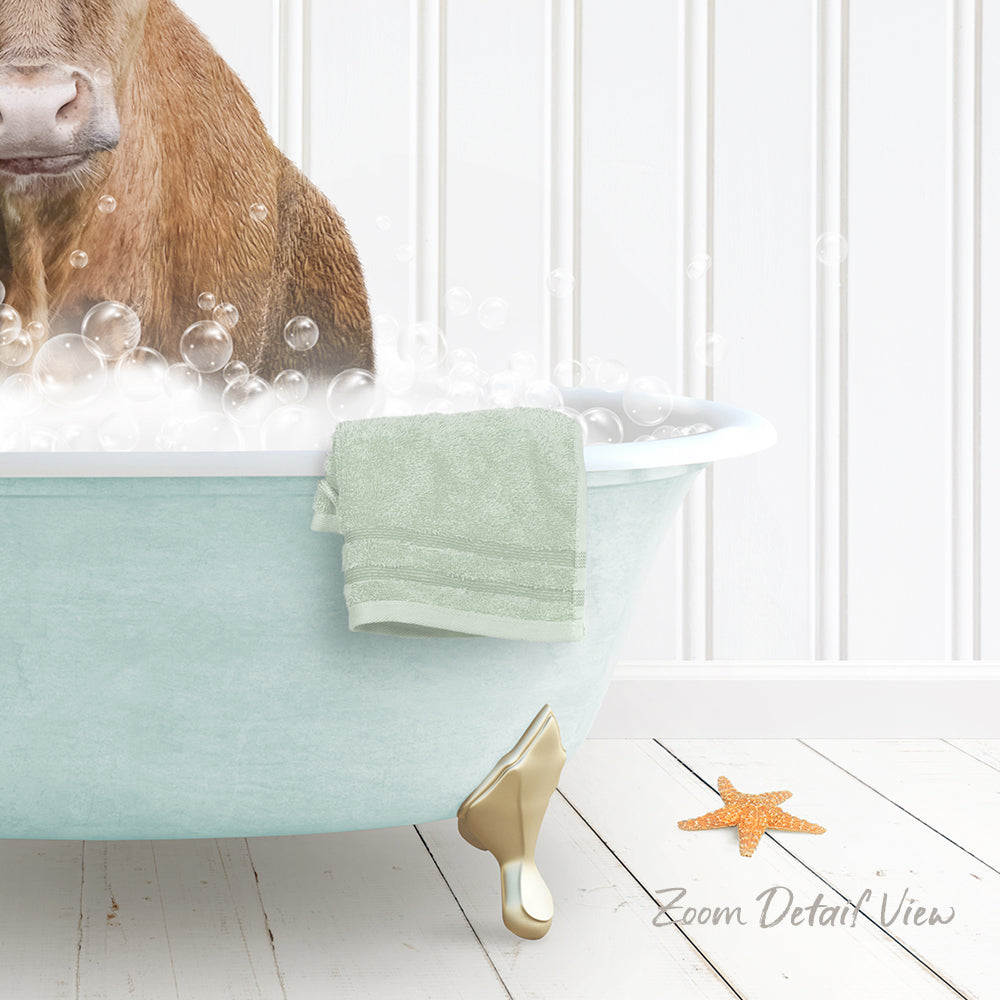 A brown cow is sitting in a light blue bathtub filled with bubbles, with a towel and starfish nearby.