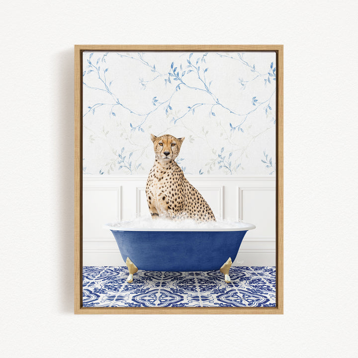 A cheetah sitting in a blue bathtub, surrounded by a blue and white patterned rug and a floral wallpaper background.
