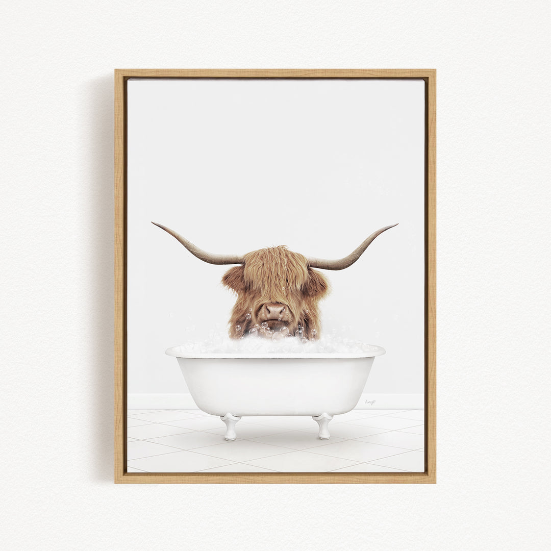 A Highland cow with long horns is sitting in a white bathtub filled with water, appearing to enjoy the bath.