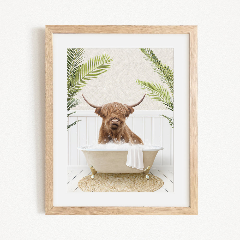 A brown cow with long horns is sitting in a white bathtub filled with water, surrounded by green plants.