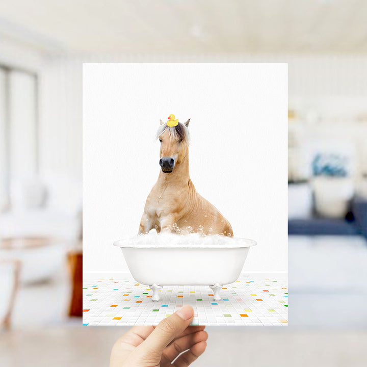 A horse sitting in a bathtub filled with bubbles, wearing a yellow rubber duck on its head.