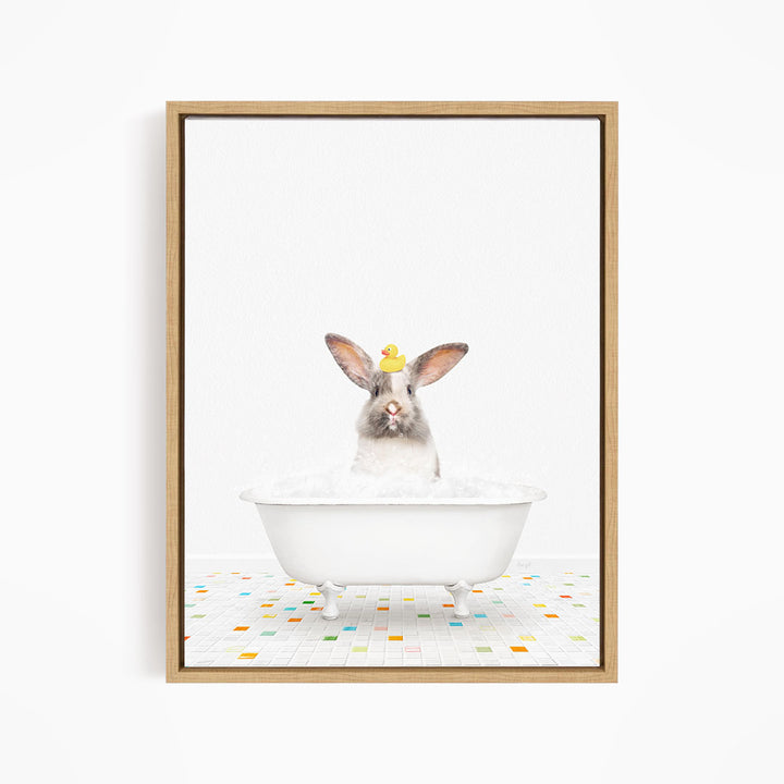 A white rabbit sitting in a white bathtub filled with bubbles, with a yellow rubber duck perched on its head.