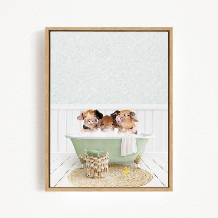 Three adorable pigs sitting in a green bathtub, surrounded by a basket of toys and a yellow rubber duck.